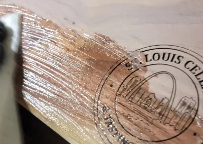 Lou Goo being applied to walnut serving board