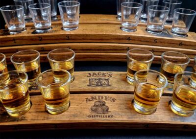 Customized engraved barrel staves holding shot glasses of whiskey